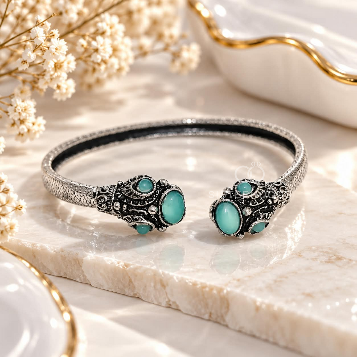 Silver and black open cuff bracelet with turquoise oval accents and ornate detailing | SISTERHOODS-SHA256:734f289eae07f25396032ccd8fa3246698a3069cd2dc04f3183e4efd6e433c3e