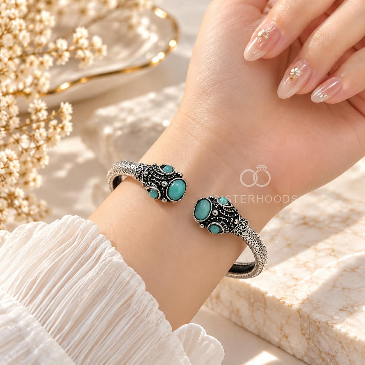 Silver and black open cuff bracelet with turquoise oval accents and ornate detailing | SISTERHOODS-SHA256:21f26cd5d219922621183b1f83cbc685b232f2f7a91aeb27beaeb535a8dde4b4