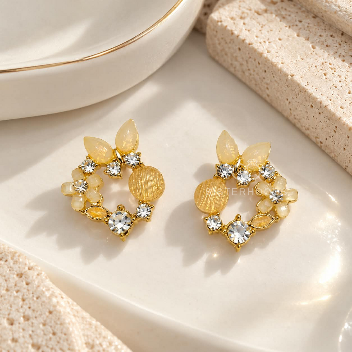 Gold-tone floral stud earring with petal details, sparkling accents and a round disc charm | SISTERHOODS-SHA256:ce71b6ac8eff58d14426929731a96bdf8c8d5e7ca3f2646e6023cecd6de22f85