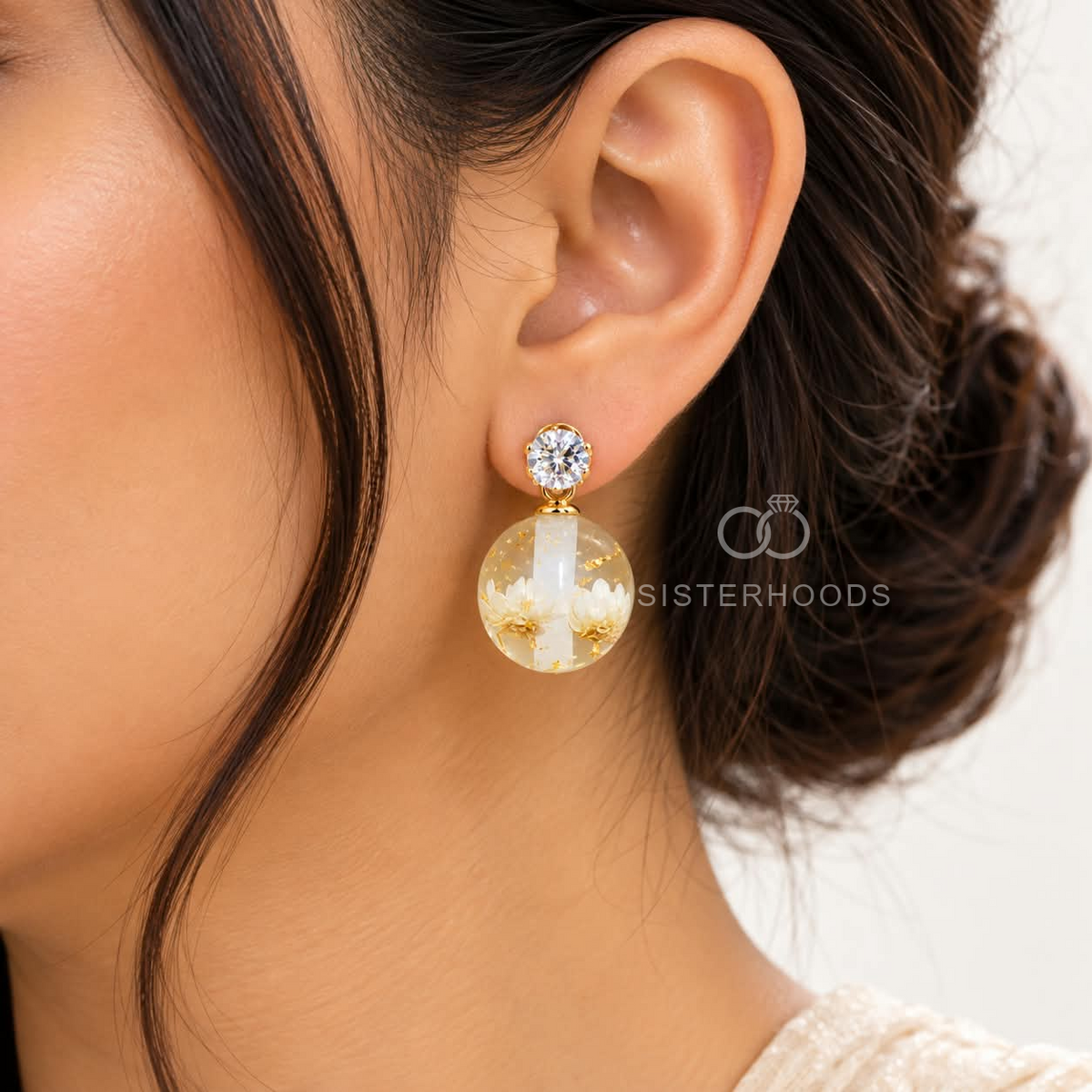 Clear floral globe dangle earrings with sparkling accents and golden details | SISTERHOODS-SHA256:bed26776d8bb25bf234ff9b326e9de1ed4e4de2d5cd308ad04d9deeb3dfa6963