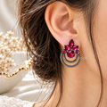 Red floral oxidized dangle earrings with concentric circular detailing | SISTERHOODS-SHA256:c85e189a82a6e901134364707eebee111b5ba4946e92b4b7babaa15706d41912