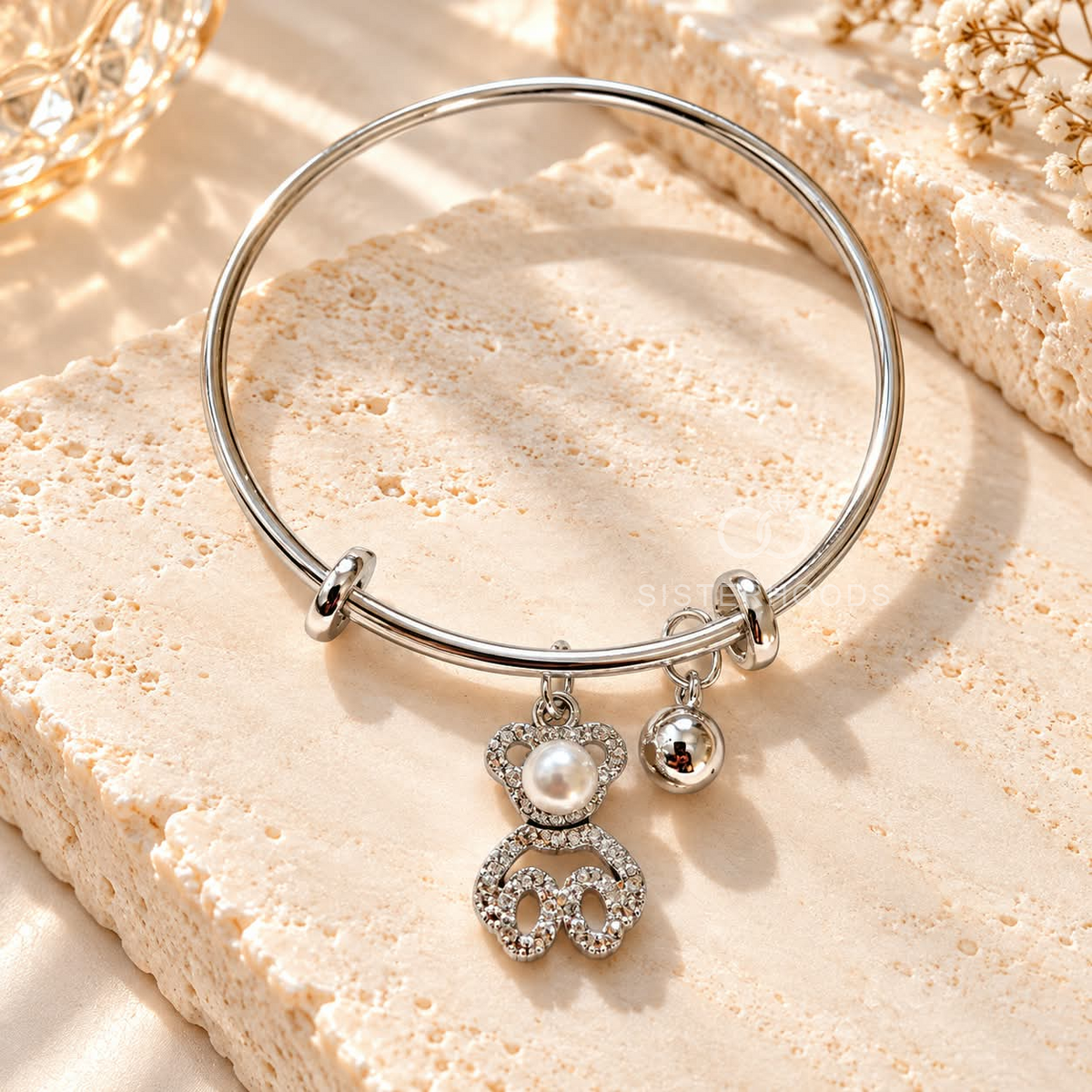 Silver-tone adjustable bracelet with pearl, sparkling accent and dangling charms | SISTERHOODS-SHA256:a938ea8b8eafef8a91ccc76965812befb7ee1169d21cda7a10fde805a2ab4bc6