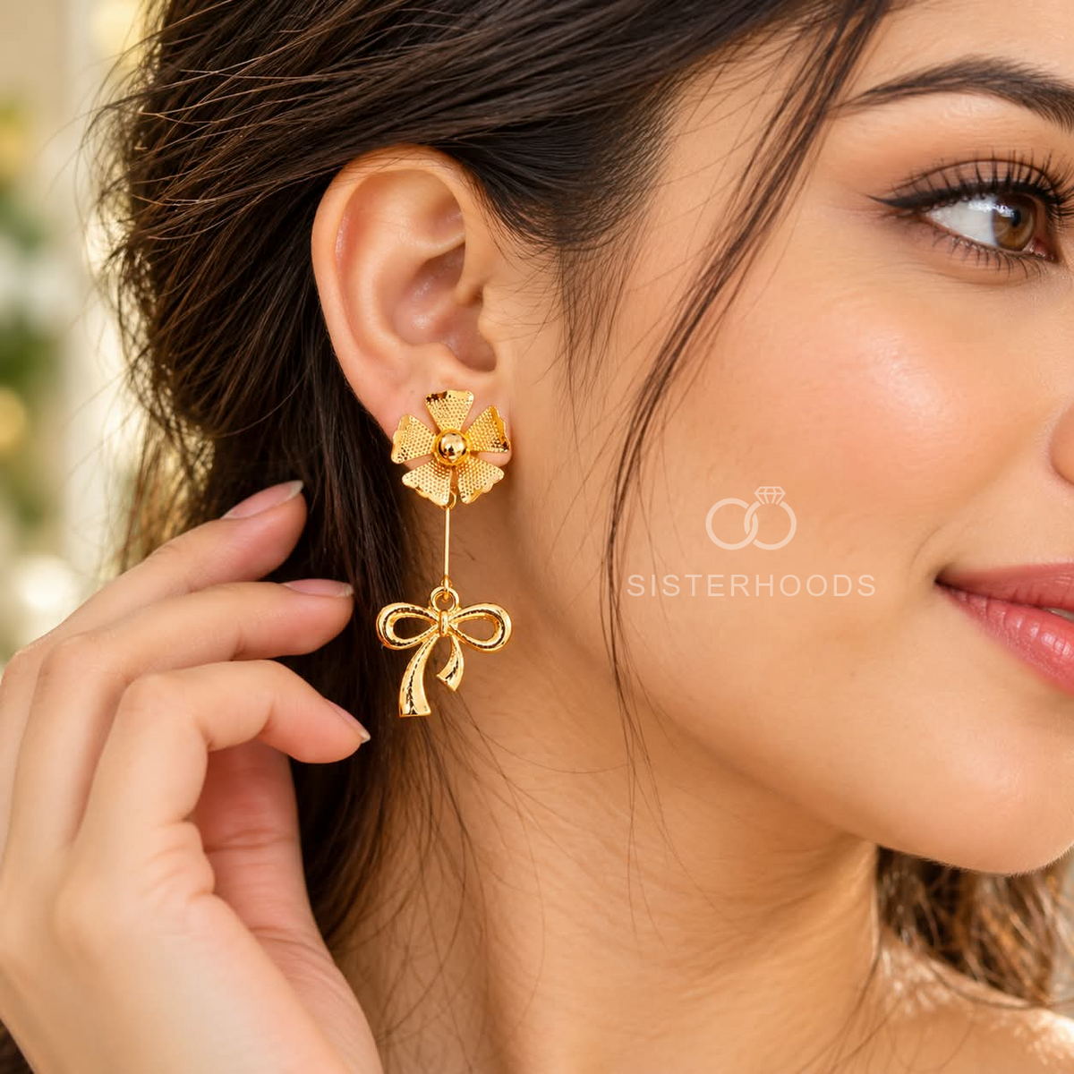 Gold-coloured floral stud earrings with long bow-shaped dangling charms | SISTERHOODS-SHA256:351639538ca08a652d3a343e9cea6cf5453eadb5ba4fdb5008ef034b6a086cf0
