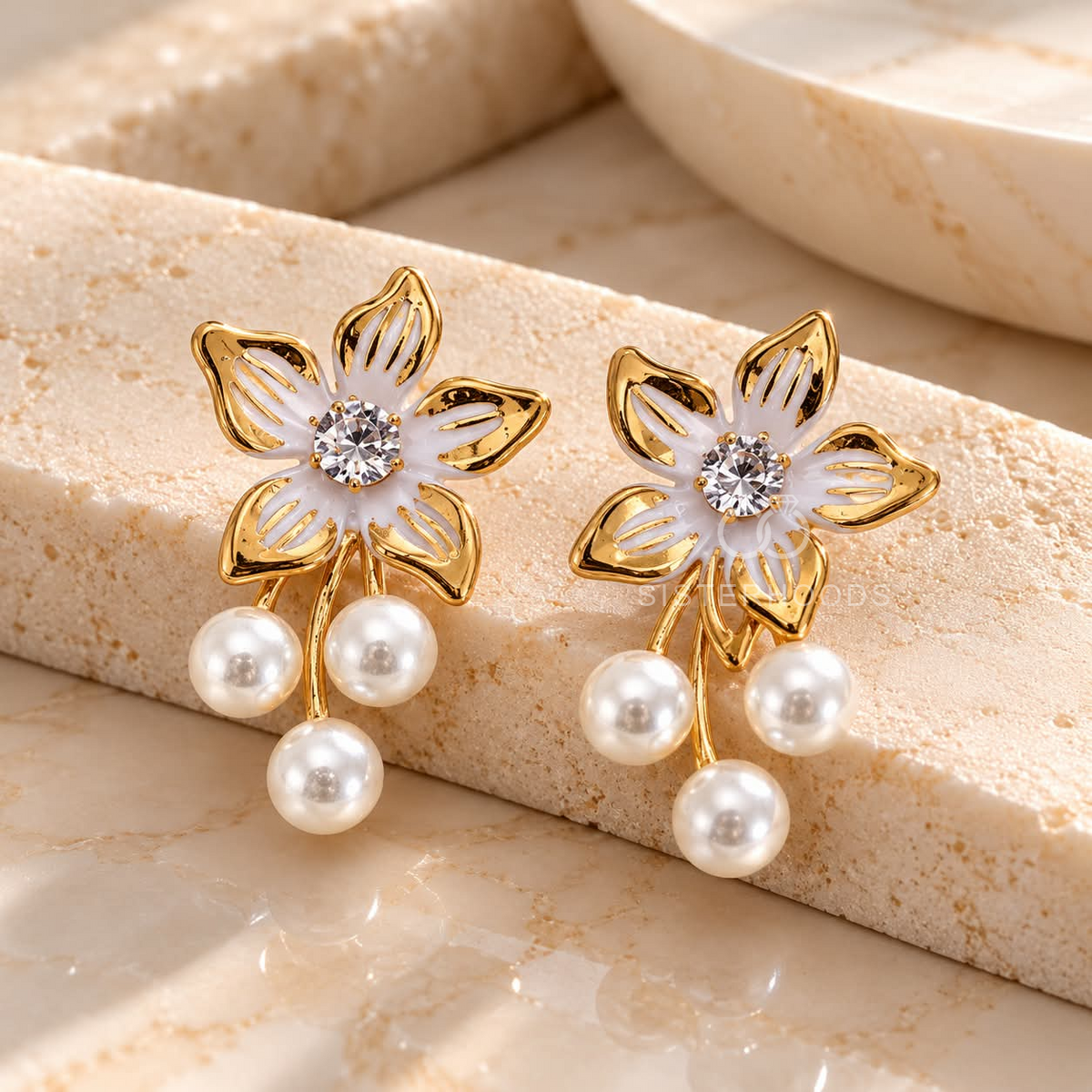 Gold-tone floral dangle earring with white pearl drops and centre accent | SISTERHOODS-SHA256:cb0684df1e0f13ffc81e300470284a0340277349be489d58b5fa7cfe5e90a26b