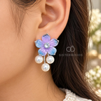 Pastel blue and lilac floral earrings with sparkling centres and three white pearl drops each | SISTERHOODS-SHA256:6efe91ec79db580a7c352d027c0f556f0d1d209c0df26320d6eeb50badbbbeb5