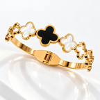 Gold-tone bracelet with alternating black and white clover motifs | SISTERHOODS-SHA256:f141024a1e828e6fb30d73b447e41307189c15144d400b19e19a9a7cf76b6fff