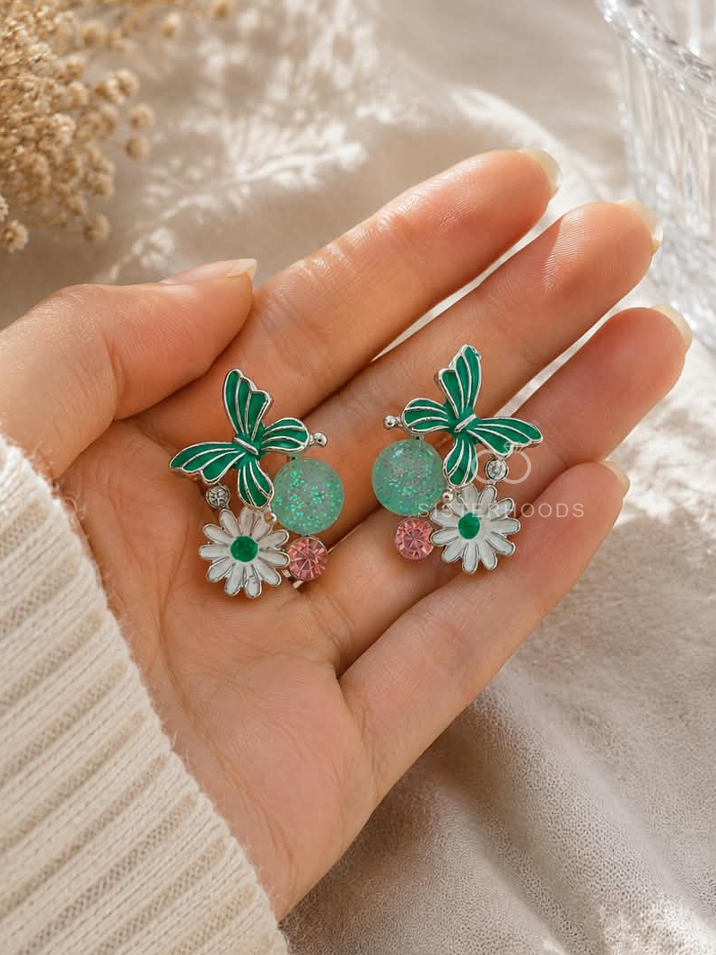 Multicolour floral dangle earrings with green butterfly and white daisy details | SISTERHOODS-SHA256:b6922b2affd9796035bc658552594c2e6a170585bec9486c47a5d6c4bd9216e1