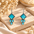 Turquoise geometric dangle earrings with square and teardrop accents | SISTERHOODS-SHA256:da2f86c99be4681927c2e3db731812a098ab5bf2fab8e2292805b4e2311a68d9
