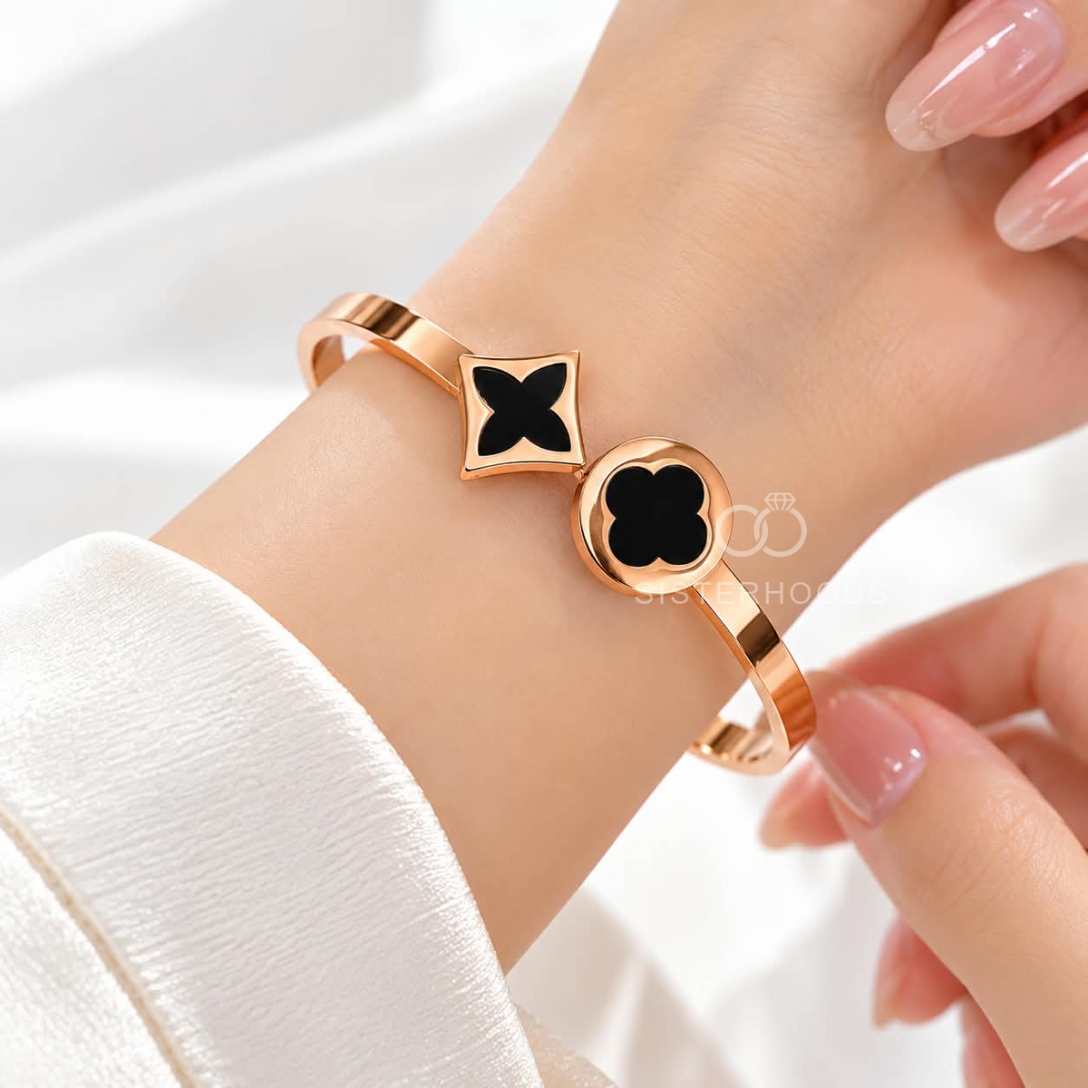 Rose gold-tone cuff bracelet with black geometric motifs | SISTERHOODS-SHA256:4e2c67af2e0bf02f5aece858d8eb032c42df93f66db8339c323bf6c52997e794