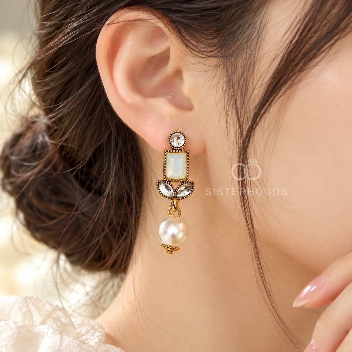 Gold-tone geometric dangle earrings with white rectangular accents, clear stones and large pearl-like drops | SISTERHOODS-SHA256:ea70edae633128d71bd0fd3659e8848ff23f62950d0f520f2f31aefcb99a7b0a