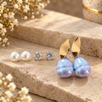 Earring assortment featuring pearl studs, crystal studs and iridescent blue drop earrings | SISTERHOODS-SHA256:417035cec0f118eb92bc5d9253635f2c8207bef4a68241291a1941926eef90f9