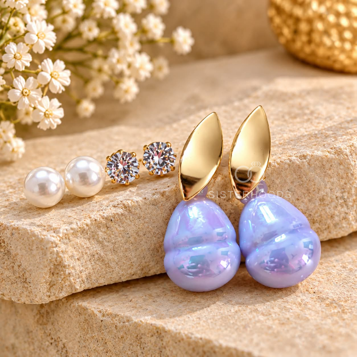 Earring assortment featuring pearl studs, crystal studs and iridescent blue drop earrings | SISTERHOODS-SHA256:110062552071c9a34d5b2a20be1d600f1263f50f72dcbe8163a27125c0c3a14a