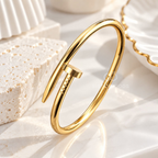 Gold open cuff bracelet with a sleek bar detail worn on the wrist | SISTERHOODS-SHA256:17b4d67a8347ec42e0720fee96dba48c99a03edcb0ce48c2f5967dd8480e0790