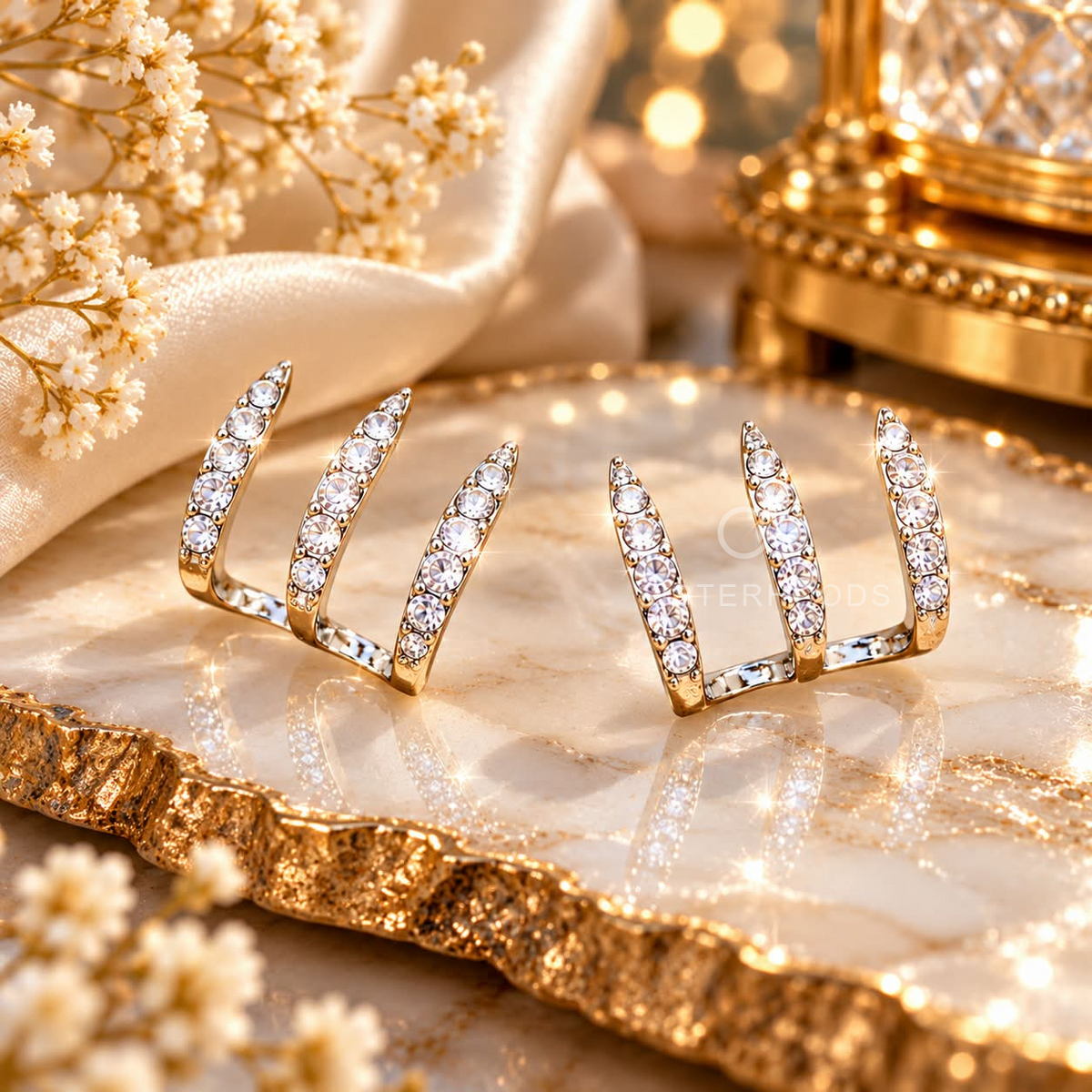 Gold-tone curved stud earrings with rows of clear stones | SISTERHOODS-SHA256:8bae26b9c02513b64160a0edebb462a2c3c7e114b93bbff5113c72a92a62e698