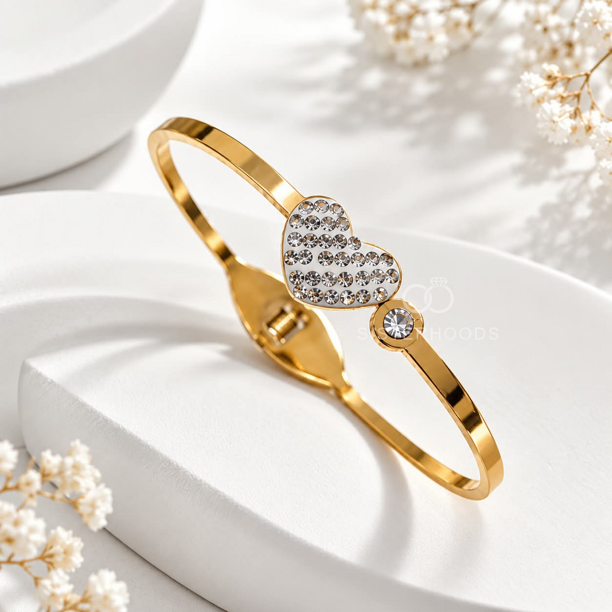 Gold-tone cuff bracelet with sparkling heart and round accents | SISTERHOODS-SHA256:8a99a3cf4195c4729c137856132944d8db92858bc1a88071dd685282197e28d4