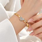 Gold-tone cuff bracelet with sparkling heart and round accents | SISTERHOODS-SHA256:0c00e901d89a5e67a1d2c9aefff2a6dbab4ba7bd003193c7c0f94ef510ff379e