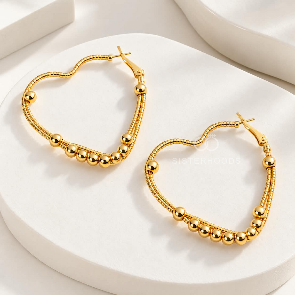 Gold-tone beaded hoop earrings with rounded silhouettes | SISTERHOODS-SHA256:296ec56548abef4074c382b94a9a42da60d7958b8bca5ae71bebac3b36cd136f