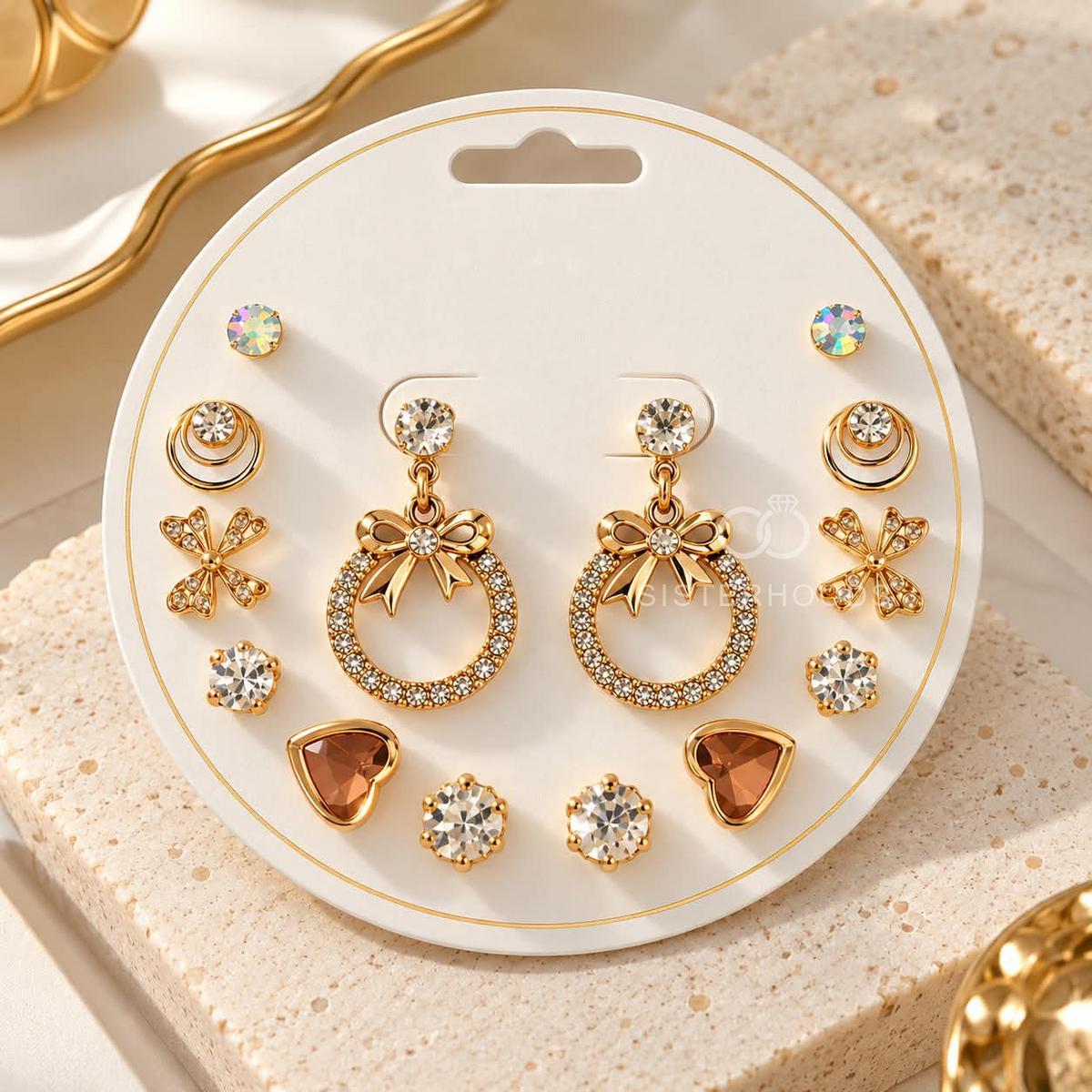 Gold-tone multi-style earring set with studs, bow drops, floral accents and heart-shaped designs | SISTERHOODS-SHA256:e4e93f4702cfcc61b3114166cacf6bb1adf001b3b70040a3251596e538a48c38