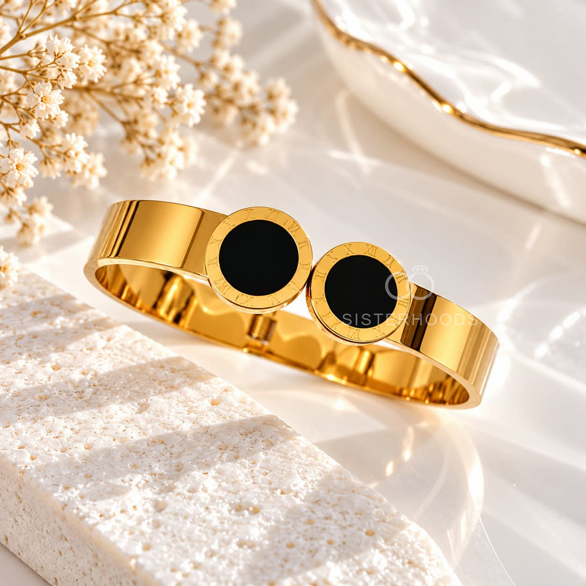 Gold cuff bracelet with twin black circular Roman numeral accents | SISTERHOODS-SHA256:6e6bde47efec5239e032e508d323359c00d8c1394ee55e7999d2977499940514