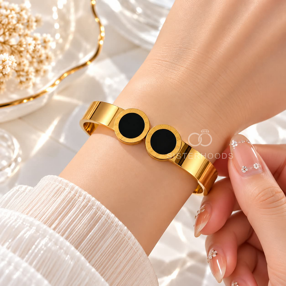 Gold cuff bracelet with twin black circular Roman numeral accents | SISTERHOODS-SHA256:d113e7d0010f481df6a7715d372b98a18297133b69a0a7f5e297b352ac8500ce