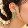 Green leaf-shaped dangle earrings with a graceful curved stem design | SISTERHOODS-SHA256:4fe894842e4df32b7eec0e3e9817fe171924bd7a3a6e89f2b921f8f00bfedc2b