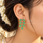 Green leaf-shaped dangle earrings with a graceful curved stem design | SISTERHOODS-SHA256:4fe894842e4df32b7eec0e3e9817fe171924bd7a3a6e89f2b921f8f00bfedc2b