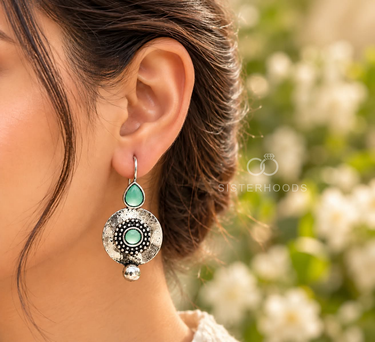 Silver-tone dangle earrings with green accents, textured circular centres and small round drops | SISTERHOODS-SHA256:094edabe9a0ff59e2df2d1594be139cfc315a78d371635874ae8e5b057c42e72