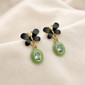 Black floral top dangle earrings with green oval accents and clear faceted centres | SISTERHOODS-SHA256:3ba5c3c847f7e9738071afc890108c60a4fbd474605fd5070fc2d41ee8e55a78