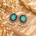 Teal oval oxidized dangle earrings with ornate detailing and white bead fringe | SISTERHOODS-SHA256:2b04191ec757c529922d2e3be52bc6b6ba65fd4b9ce63e17e1f6bab14b908b60