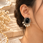 Black oval dangle earrings with ornate silver-toned detailing and white bead drops | SISTERHOODS-SHA256:774f8b2f3c7773ef41cb9b467f44c2c3e30f9b017283b17e6858406d48250aeb
