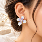 White and lilac floral stud earrings with pearl centres and gold-tone detailing | SISTERHOODS-SHA256:3c2838a1813c147d5d35e86790b75a998cf6308f3a4f00d332c27b9eab4bce84