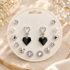 Multi-pair silver earring set with black heart, star, pearl-style and sparkling stud designs | SISTERHOODS-SHA256:122e24189988cfc60e5faed176c4148b53ff0d199b9929e1a3619c5d75c90750