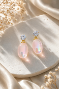 Pink oval dangle earrings with clear faceted tops and golden details | SISTERHOODS-SHA256:b30e30dbe0f9a4a95f7ee2b40770536493630852642b61917f15ef8ce1da3ff4