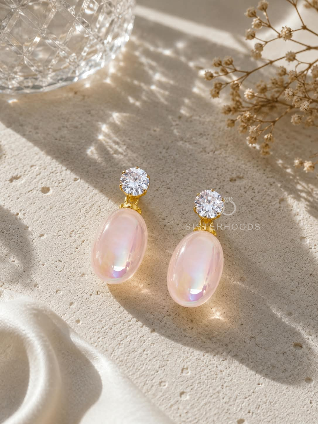 Pink oval dangle earrings with clear faceted tops and golden details | SISTERHOODS-SHA256:9ea5ccce92158ab269e8f104d844a067bc9facf713095e5e516cef3bef0207d3