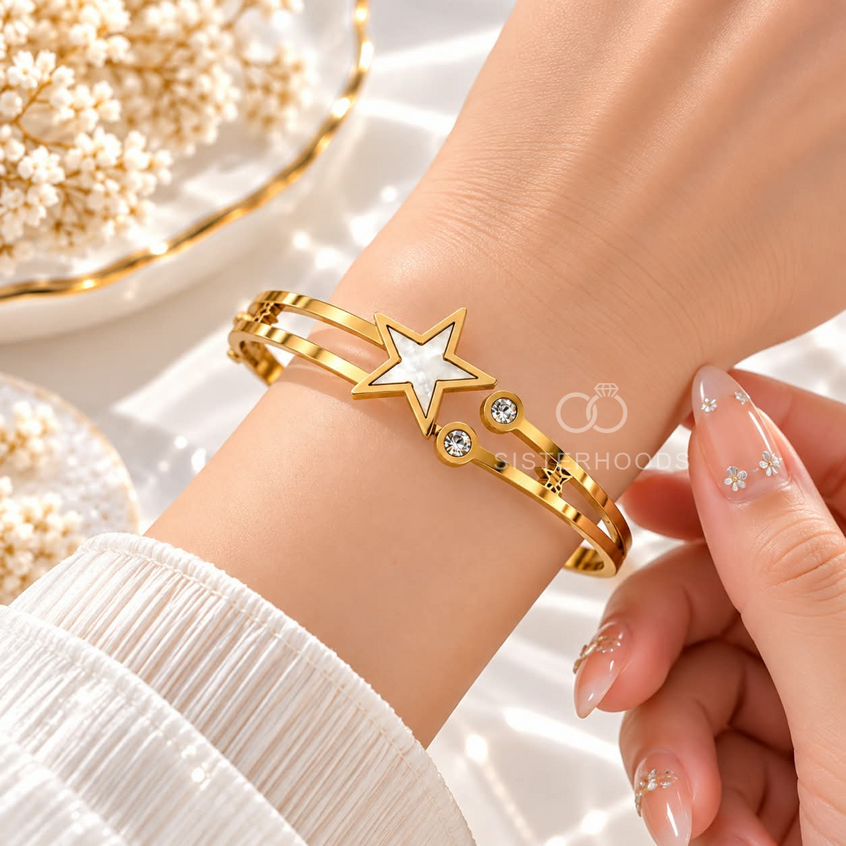 Gold-tone cuff bracelet with a white star centre and clear accent stones | SISTERHOODS-SHA256:516306186d46c1902213cc9b2ceba5342cd48ef7215af8d0be7424f106a04362