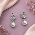 Silver and lavender leaf drop earrings with white round dangling accents | SISTERHOODS-SHA256:8f45e1bcb2aaa67428541aad9467bf8d0d5b46fccf9b6d79fb0473655786d43b