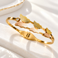 Golden cuff bracelet with textured petal motifs and rose-toned accents | SISTERHOODS-SHA256:16a58e5f13087e2bcb00c6eaabeab677b3884bbf680fb5b33a8aef3191373f36