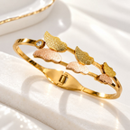 Golden cuff bracelet with textured petal motifs and rose-toned accents | SISTERHOODS-SHA256:16a58e5f13087e2bcb00c6eaabeab677b3884bbf680fb5b33a8aef3191373f36