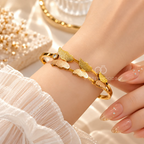 Golden cuff bracelet with textured petal motifs and rose-toned accents | SISTERHOODS-SHA256:a0bd001eebcb03057b0246ea524d273c34883963d06a62a33c7585337a32e7c3