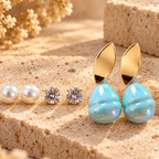 Gold-tone leaf stud earrings with luminous aqua-blue rounded drops | SISTERHOODS-SHA256:988f0f67b471443102d1556285efe124e1ab4220d2fd26fcab4b0e29dec8b107