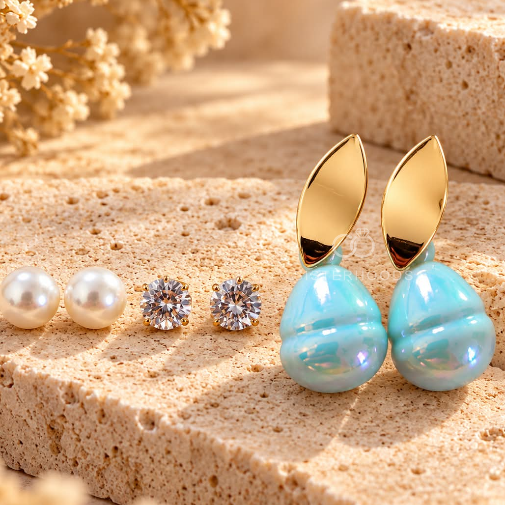 Gold-tone leaf stud earrings with luminous aqua-blue rounded drops | SISTERHOODS-SHA256:988f0f67b471443102d1556285efe124e1ab4220d2fd26fcab4b0e29dec8b107