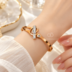 Gold-tone open bracelet with geometric details and crystal accents | SISTERHOODS-SHA256:178edafbf32c5839393721ee0f1b456bfdd8f01a8ba01521237ed1065681ccdf