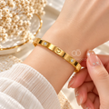 Gold tone cuff bracelet with heart motifs and clear crystal accents | SISTERHOODS-SHA256:90a90497ec4868225c6be4dc12320a2ef04423f308b58955b79bc429ec39352e