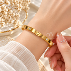 Gold tone cuff bracelet with heart motifs and clear crystal accents | SISTERHOODS-SHA256:90a90497ec4868225c6be4dc12320a2ef04423f308b58955b79bc429ec39352e