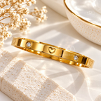 Gold tone cuff bracelet with heart motifs and clear crystal accents | SISTERHOODS-SHA256:c38e1457aac068a2f3d208da61f7c553d9547c00b4b125c34d2f5a350495be93