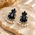 Black floral dangle earrings with silver-toned detailing and white bead accents | SISTERHOODS-SHA256:bfd92b307acab371f71683bb2686d545d1af8b7d8f28794edb5f27b84d5579ff