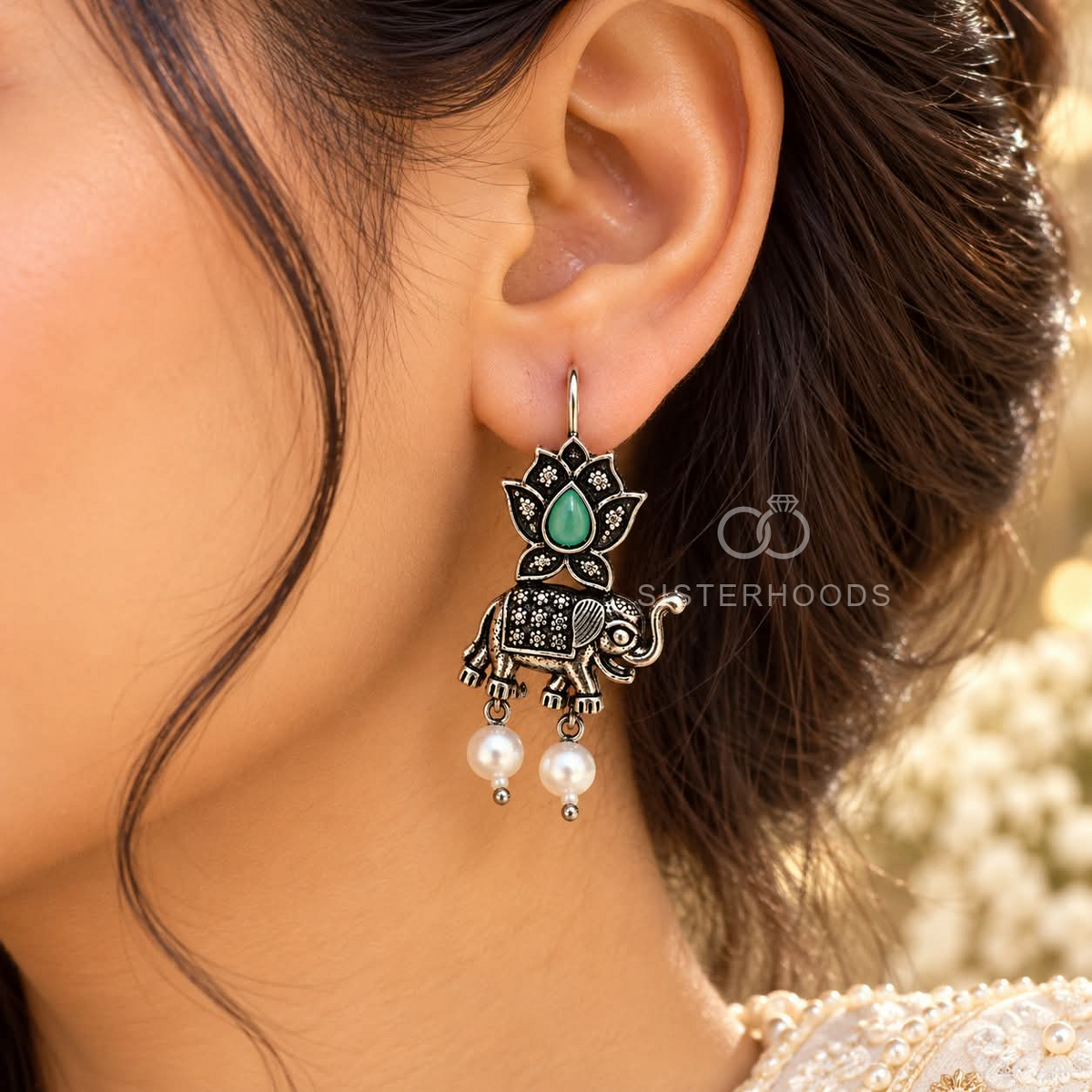 Oxidized silver tone elephant and lotus dangle earrings with green centre details and white bead drops | SISTERHOODS-SHA256:97a2e21d279d26db7d948da698af7853976d5ae1a96432e670f35458b28ebf1a
