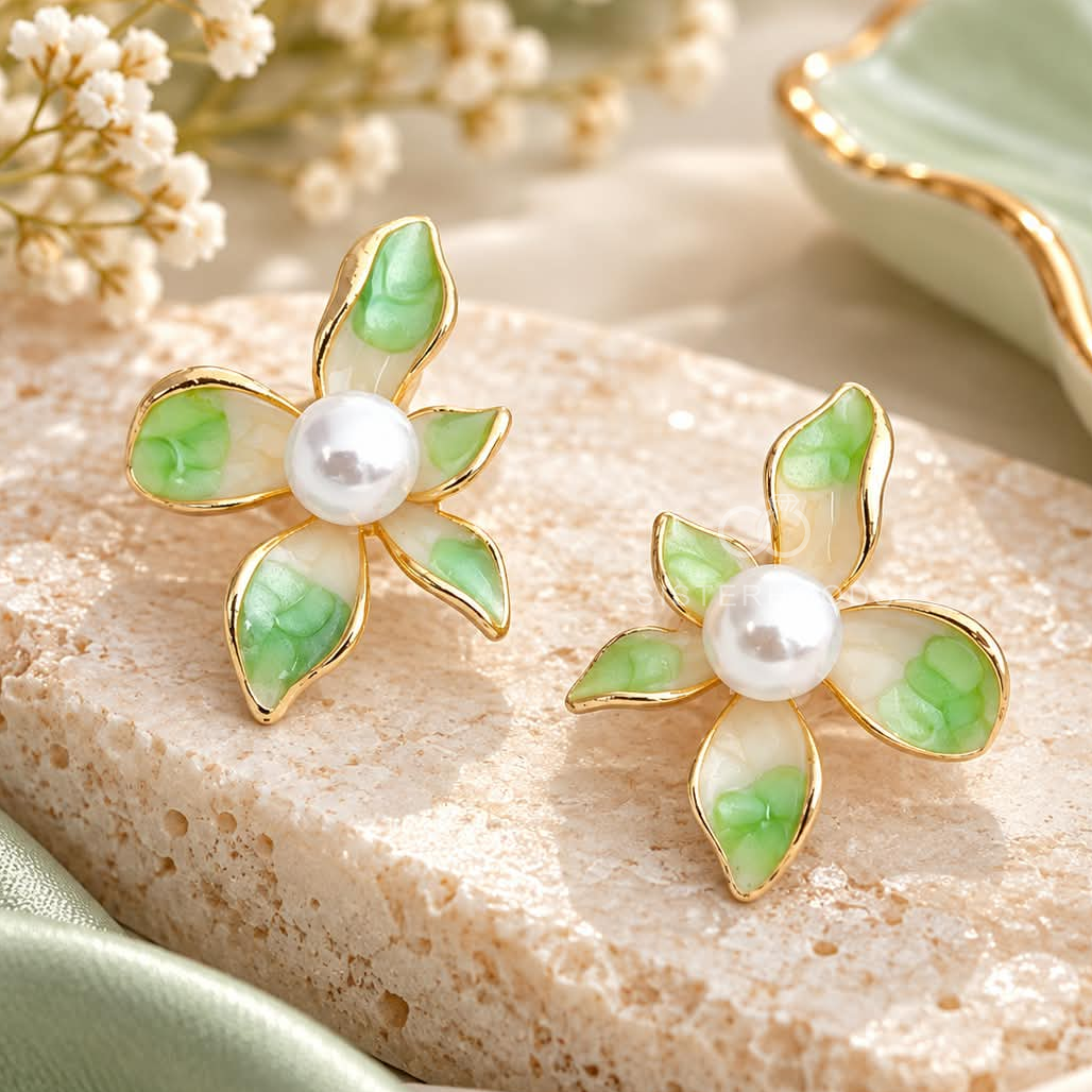 Green and white floral stud earrings with pearl centres and gold-tone outlines | SISTERHOODS-SHA256:839f6e626da4d29c5ab4d0362ac8d790a751fc61c89315f15b07af81465d530c