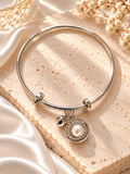 Silver adjustable bracelet with pearl circular charm and sparkling accents | SISTERHOODS-SHA256:66d3326048f8b5f38d6a6548aee13809dc653267b902a0f0b1c00d4e8060d2ae