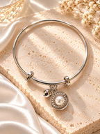 Silver adjustable bracelet with pearl circular charm and sparkling accents | SISTERHOODS-SHA256:66d3326048f8b5f38d6a6548aee13809dc653267b902a0f0b1c00d4e8060d2ae